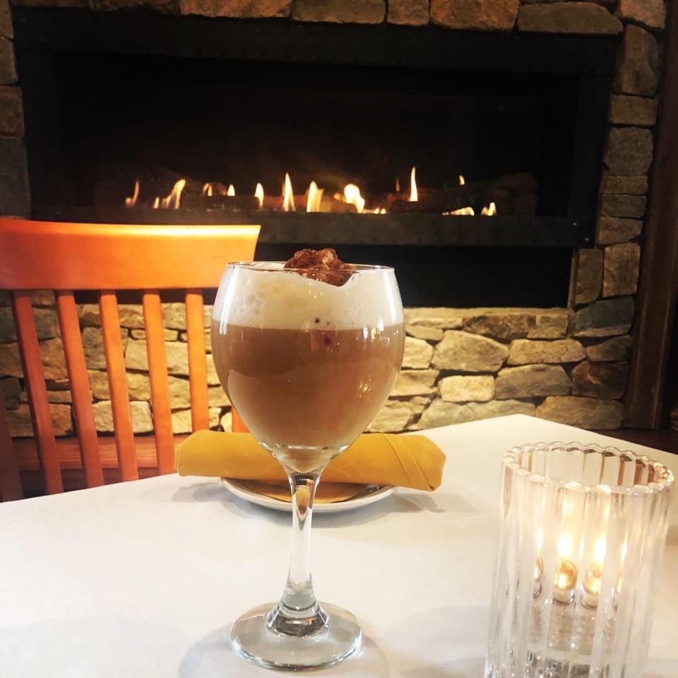 Enjoy a winter drink next to the fireplace at Coachmen's Lodge in Bellingham.