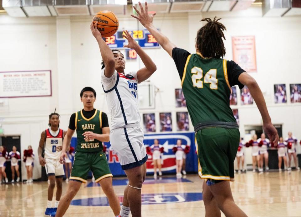 Beyer’s Noah Ramilo attacks the hoop as Davis’ Caynan Gardner defends in the Western Athletic Conference game at Beyer High School in Modesto, Calif., Friday, Feb. 2, 2024.