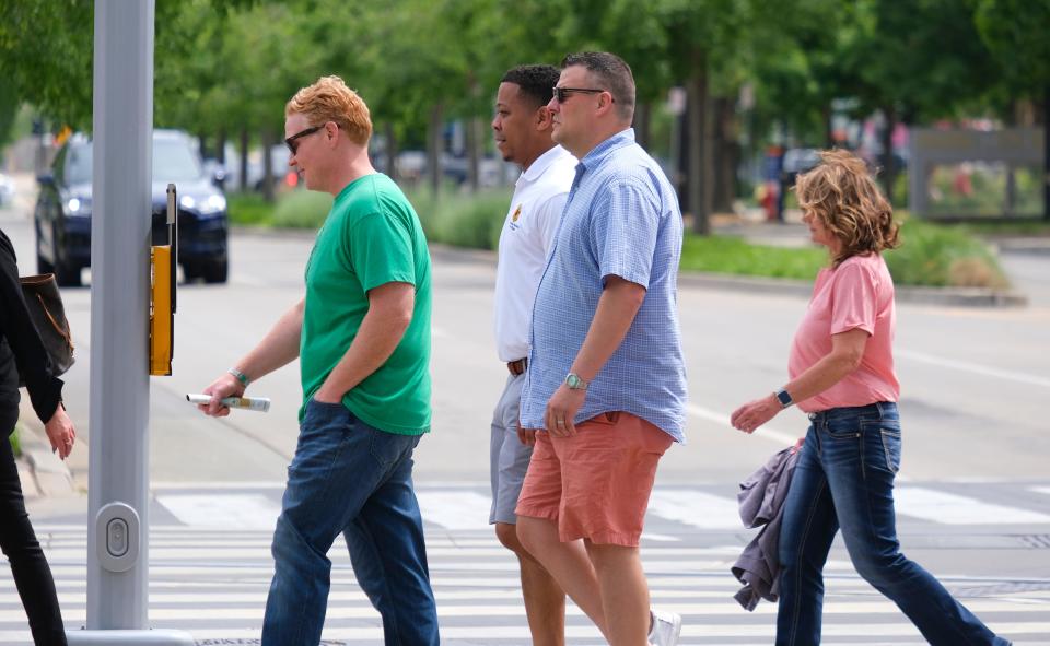 Mask regulations have been relaxed as people move about Friday in Oklahoma City.