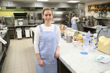 Baker Sophie Cabot poses in the kitchen, where she prepares the red velvet and chocolate wedding cake for the marriage at Windsor Castle of Britain's Princess Eugenie and Jack Brooksbank, at Buckingham Palace in London, Britain, October 10, 2018. Chris Jackson/Pool via REUTERS