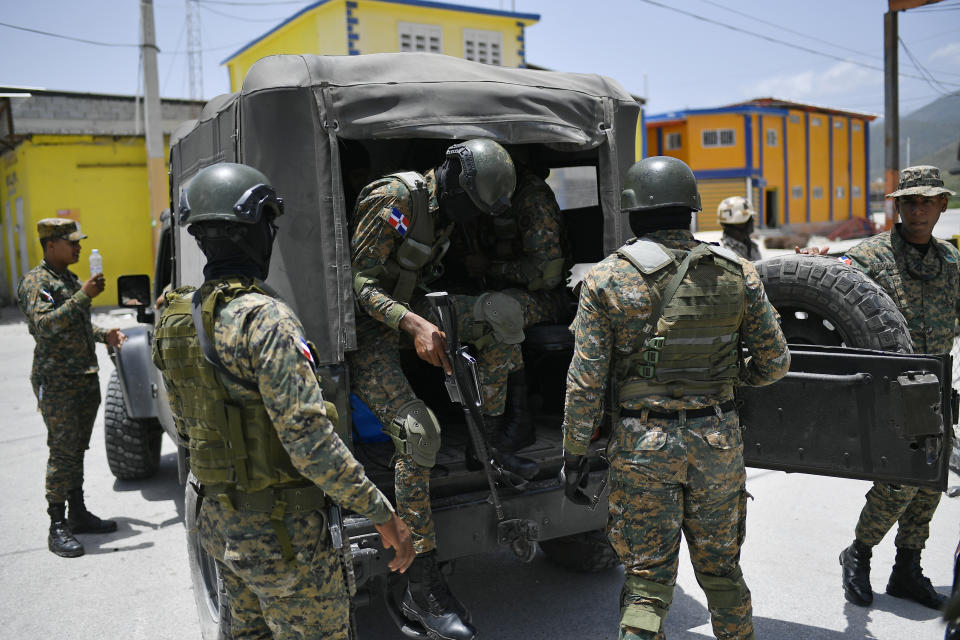 Soldiers arrive for a change of guard at the border with Haiti in Jimani, the Dominican Republic, Friday, July 9, 2021. Dominican President Luís Abinader ordered the closure of the border on Wednesday after Haiti's government reported gunmen had assassinated Haitian President Jovenel Moïse. (AP Photo/Matias Delacroix)