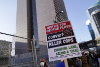 Demonstrators gather outside the Hennepin County Government Center, background, on Monday, March 8, 2021, in Minneapolis where the trial for former Minneapolis police officer Derek Chauvin began with jury selection. Chauvin is charged with murder in the death of George Floyd during an arrest last May in Minneapolis. (AP Photo/Jim Mone)