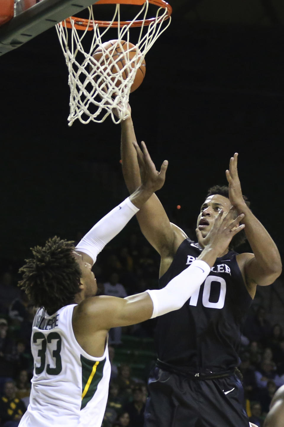 Butler forward Bryce Nze, right, shoots over Baylor forward Freddie Gillespie in the first half of an NCAA college basketball game, Tuesday, Dec. 10, 2019, in Waco, Texas. (AP Photo/Rod Aydelotte)