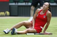 Jelena Jankovic of Serbia slips and falls in her women's singles tennis match against Serena Williams of the United States at the All England Lawn Tennis Club during the London 2012 Olympics Games July 28, 2012.