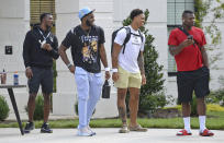 Carolina Panthers players, from left, safety Sam Franklin, defensive end Brian Burns, defensive end Yetur Gross-Matos and defensive end Marquis Haynes wait outside the team's dormitory at NFL football training camp, Tuesday, July 27, 2021, at Wofford College in Spartanburg, S.C. (Jeff Siner/The Charlotte Observer via AP)