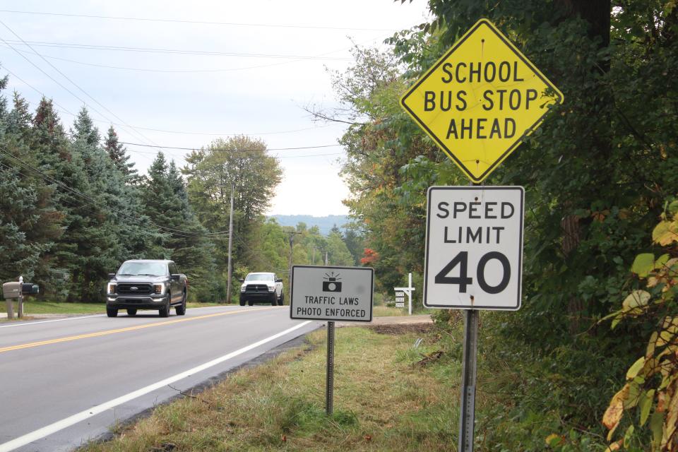 Vehicles pass a photo enforcement sign on state Route 303 in a 40 mph zone. This is one of nine enforcement signs located in the village limits.