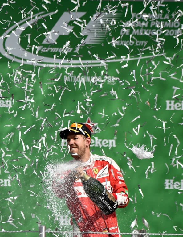 Ferrari driver German Sebastian Vettel celebrates his third place in Mexico City on October 30, 2016