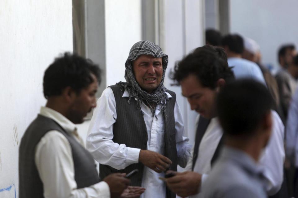 Afghans mourn victims the the deadly suicide bombing that targeted a training class in a private building in western Kabul (AP)