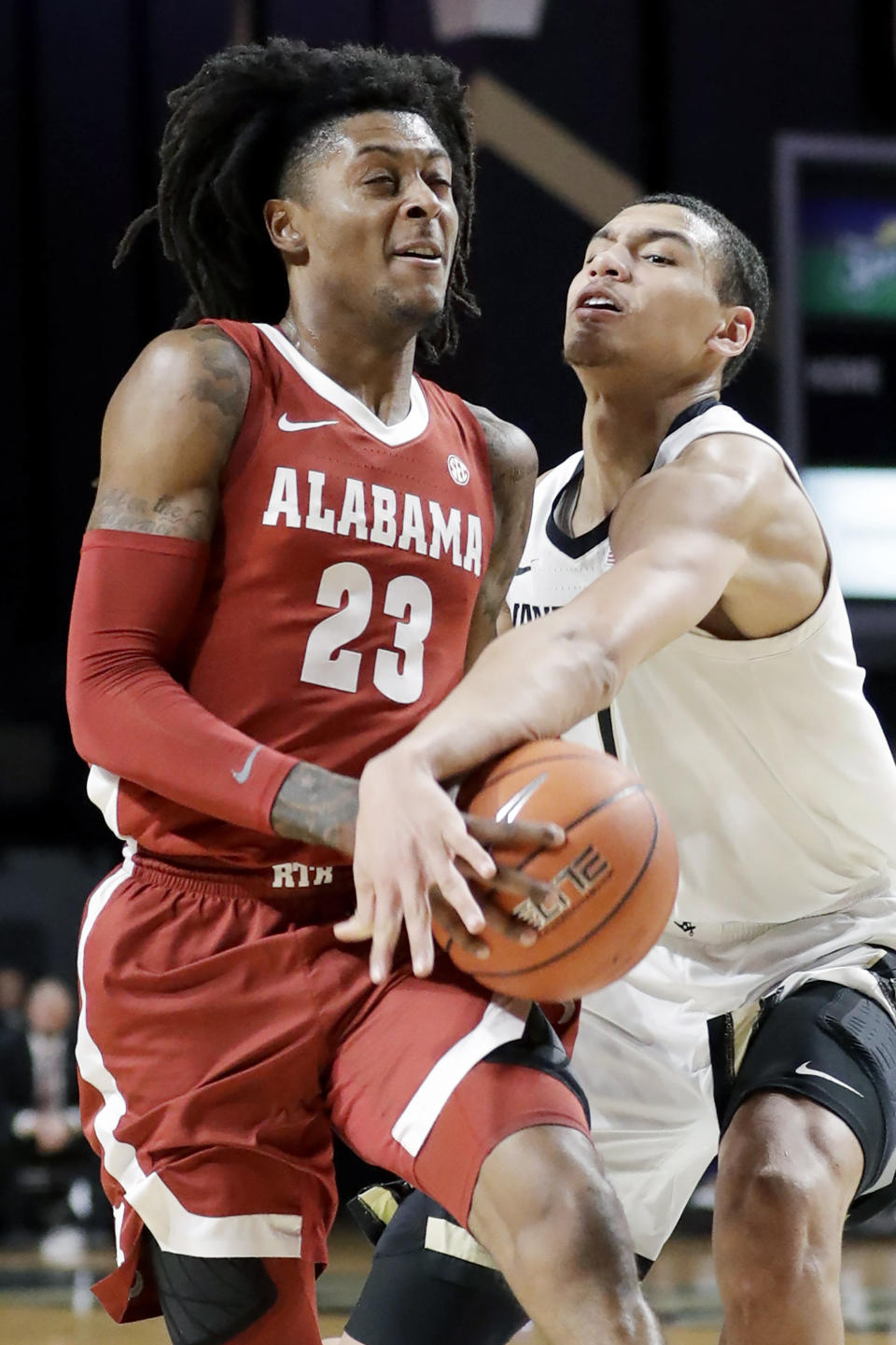 Alabama guard John Petty Jr. (23) drives against Vanderbilt forward Dylan Disu in the second half of an NCAA college basketball game Wednesday, Jan. 22, 2020, in Nashville, Tenn. (AP Photo/Mark Humphrey)