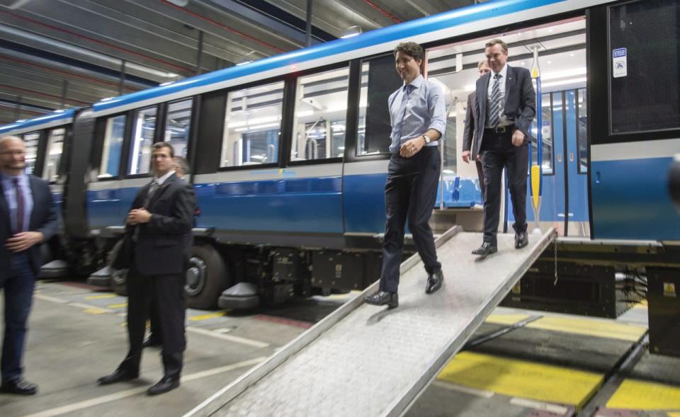 Prime Minister Justin Trudeau steps off a subway car as he tours a garage of the Montreal Transportation Commission, Wednesday, April 6, 2016 in Montreal. THE CANADIAN PRESS/Paul Chiasson