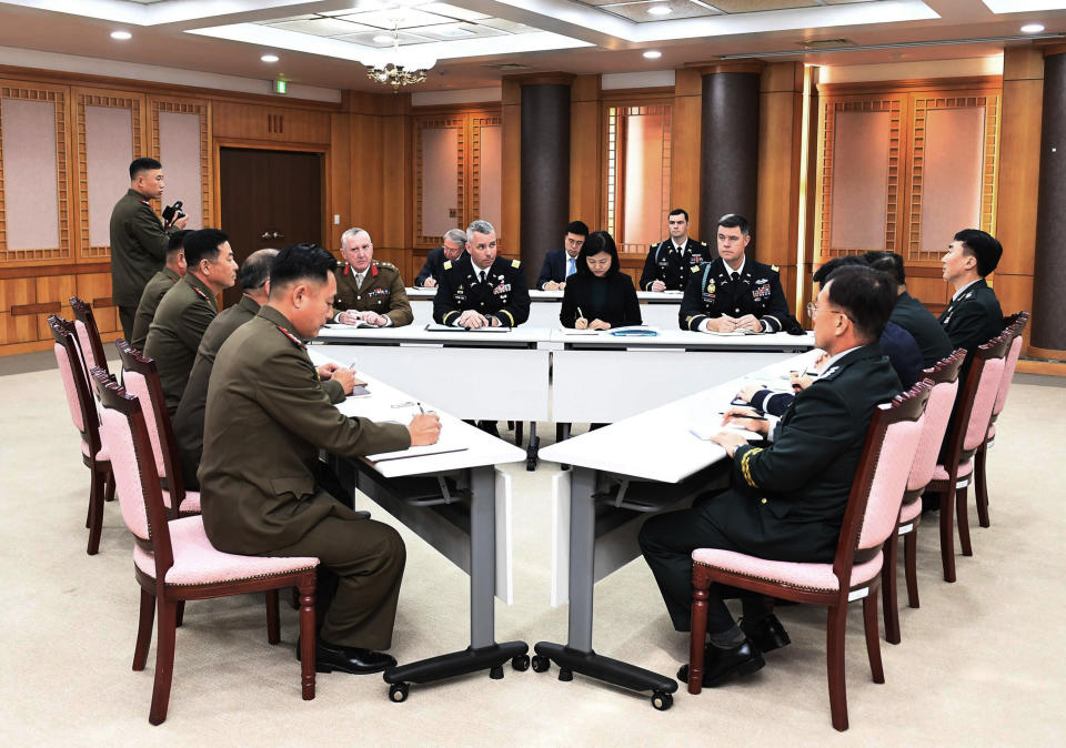 In this photo provided by South Korea Defense Ministry, the U.S.-led United Nations Command, center, South Korean and North Korean, left, military officers attend a meeting at the southern side of Panmunjom in the Demilitarized Zone, South Korea, Tuesday, Oct. 16, 2018. The rival Koreas and the U.S.-led United Nations Command were meeting Tuesday to discuss efforts to disarm a military zone the rivals control within their shared border under a peace agreement between the Koreas. (South Korea Defense Ministry via AP)