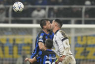Inter Milan's Francesco Acerbi fights for the ball with Real Sociedad's Igor Zubeldia during a Champions League group D soccer match between Inter Milan and Real Sociedad at the San Siro stadium in Milan, Italy, Tuesday, Dec. 12, 2023. (AP Photo/Antonio Calanni)