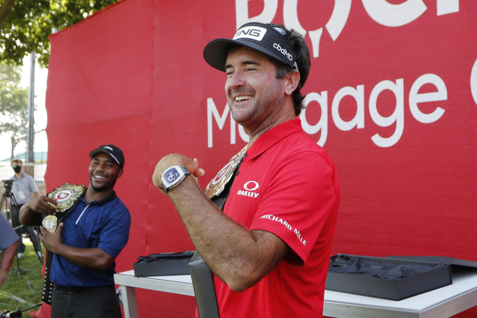 Bubba Watson and Harold Varner III, left, show off the winner's belts after their win in a nine-hole exhibition against Jason Day and Wesley Bryan ahead of the Rocket Mortgage Classic golf tournament, Wednesday, July 1, 2020, at the Detroit Golf Club in Detroit. (AP Photo/Carlos Osorio)