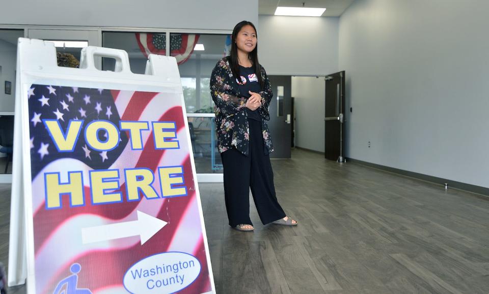 South Hagerstown High School student Mae Crews works as a greeter at the county election board headquarters on Virginia Avenue in Halfway Thursday on the first day of early voting for the Maryland gubernatorial primary election.