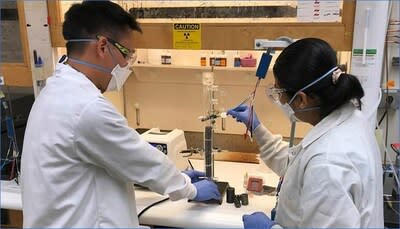 Simon Pang (left) and Buddhinie Jayathilake assemble and prepare a prototype bubble column electrobioreactor to test additively manufactured three-dimensional electrodes. Under their project, excess renewable electricity from wind and solar sources would be stored in chemical bonds as renewable natural gas. Photo by Nathan Ellebracht.