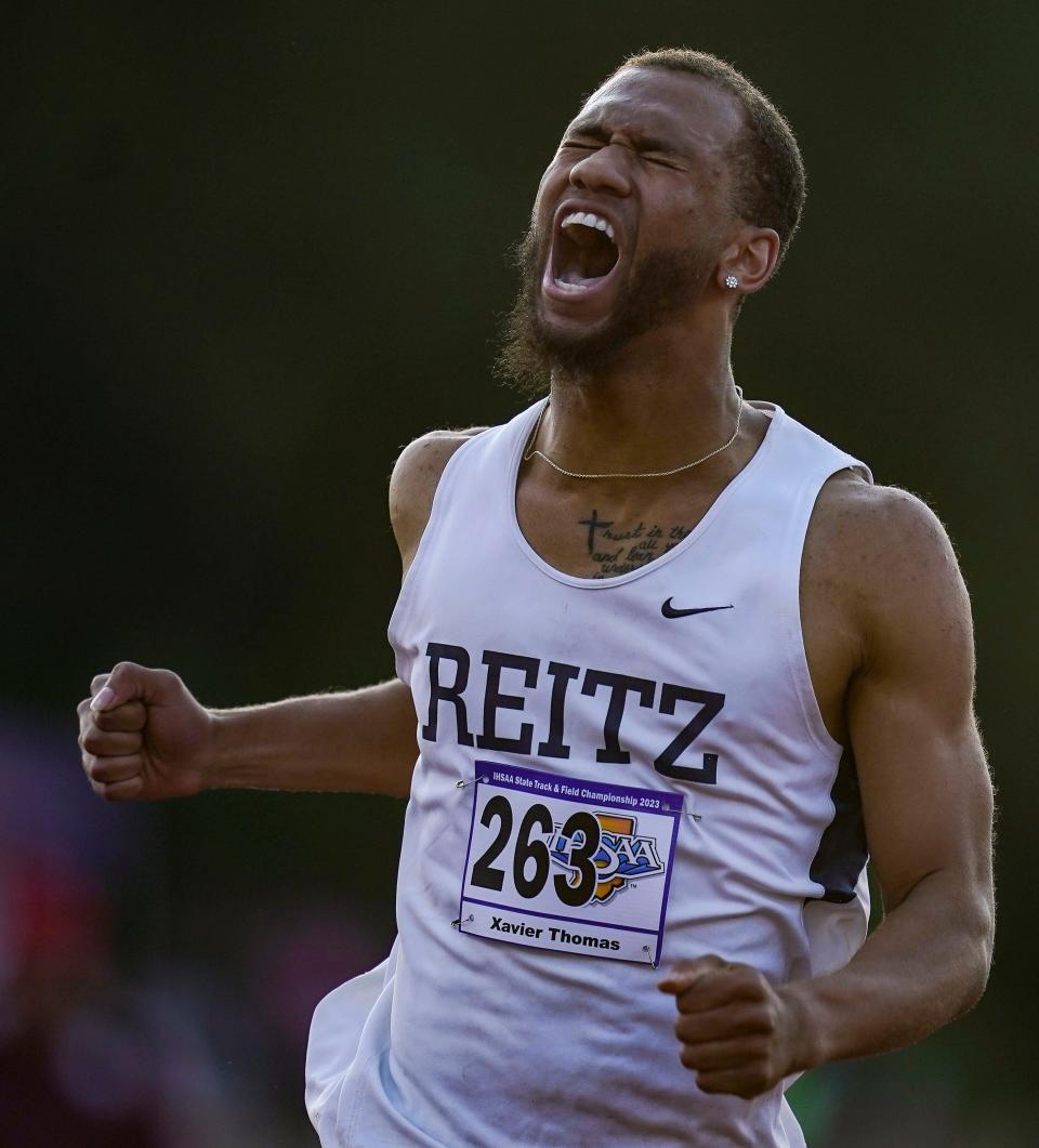 Evansville F.J. Reitz's Xavier Thomas yells in excitement after competing in the 200 meter dash Friday, June 2, 2023, during the IHSAA boys track and field state finals at Robert C. Haugh Track and Field Complex at Indiana University in Bloomington. 