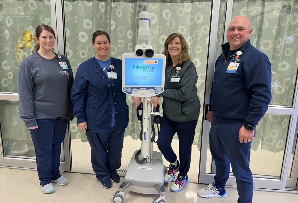(Left to right) HSHS St. Joseph’s Hospital Highland emergency department RN’s Alyson and Colleen; Carol Lowery, team lead; and Patrick Small, emergency department manager, with the telemedicine cart and monitor used by St. Joseph’s Hospital to help rapidly diagnose stroke patients by connecting with a tele-neurologist for examination. Provided