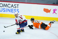 Washington Capitals' Alex Ovechkin (8) keeps the puck away from Philadelphia Flyers' Shayne Gostisbehere (53) during the third period of an NHL hockey game, Sunday, March 7, 2021, in Philadelphia. (AP Photo/Matt Slocum)