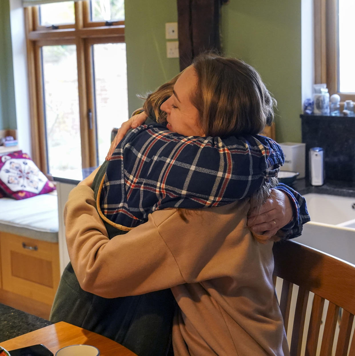 Ukrainian refugees Irina Kryvoviaz (right) with their host Sarah Allen-Stevens as they settle into their new home in North Moreton, Oxfordshire