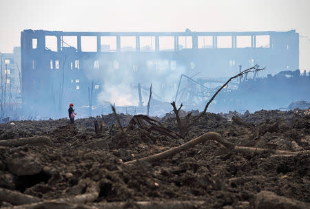 A woman walks at the site at the pesticide plant owned by Tianjiayi Chemical following an explosion, in Xiangshui county, Yancheng, Jiangsu province, China March 23, 2019. REUTERS/Aly Song