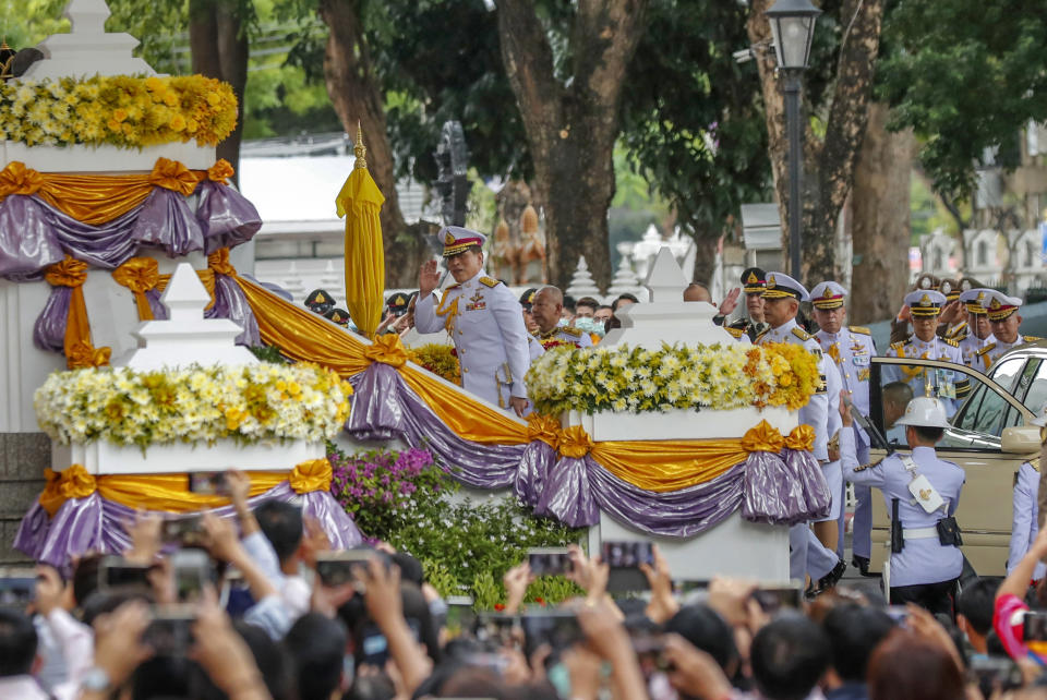 King Maha Vajiralongkorn, center, waves as he arrives to participate in a graduation ceremony at Thammasat University in Bangkok, Thailand, Friday, Oct. 30, 2020. (AP Photo/Sakchai Lalit)