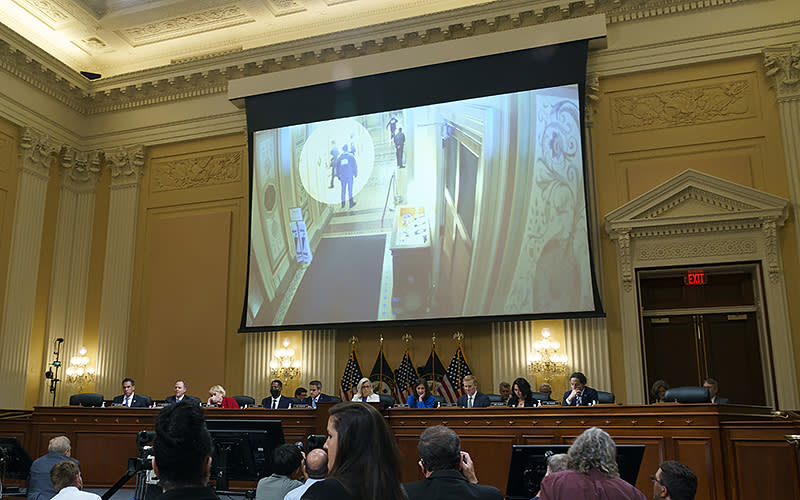 Footage of Sen. Josh Hawley (R-Mo.) running in the Capitol is seen during a July 21 hearing of the House committee investigating the Jan. 6, 2021, riot at the Capitol. <em>Greg Nash</em>