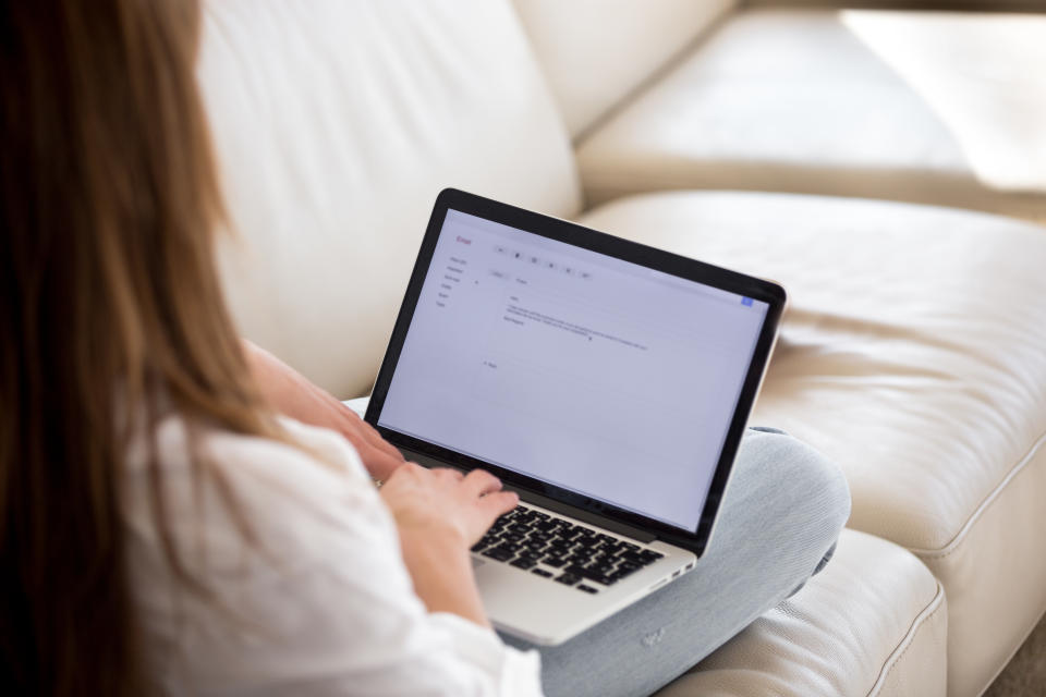 A woman typing on a laptop