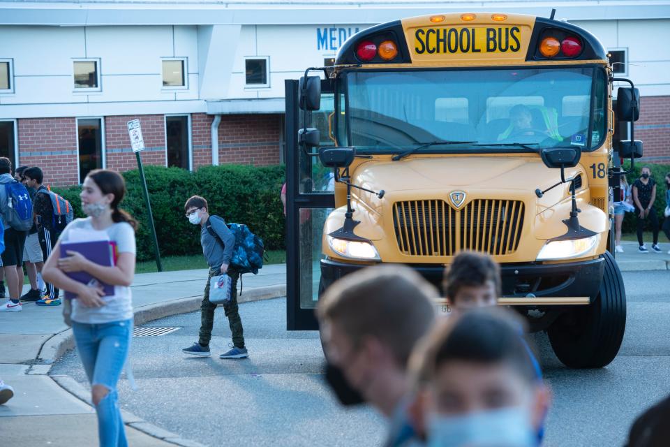 Students exit their school bus after it pulls up to Anthony Wayne Middle School for the morning drop-off in Wayne, N.J. on Friday Sept. 24, 2021. 