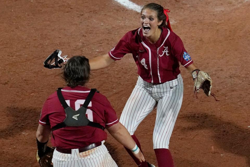 Alabama pitcher Montana Fouts, right, celebrates her perfect game with Bailey Hemphill, after the team's NCAA Women's College World Series softball game against UCLA on Friday, June 4, 2021, in Oklahoma City. (AP Photo/Sue Ogrocki)