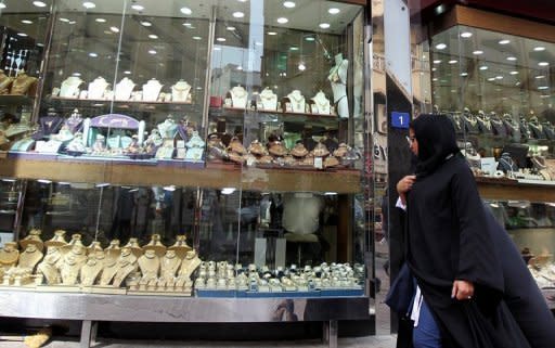 A woman walk past a window display in a gold market in Dubai. The UAE is home to more than 8mln people, only 950,000 of them UAE citizens. The rest are foreign, and young Emirati men are increasingly choosing to marry them instead