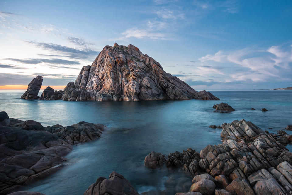 A photo of the triangle-shaped Sugarloaf Rock rising dramatically up out of the ocean in the Margaret River and Dunsborough area of Western Australia.