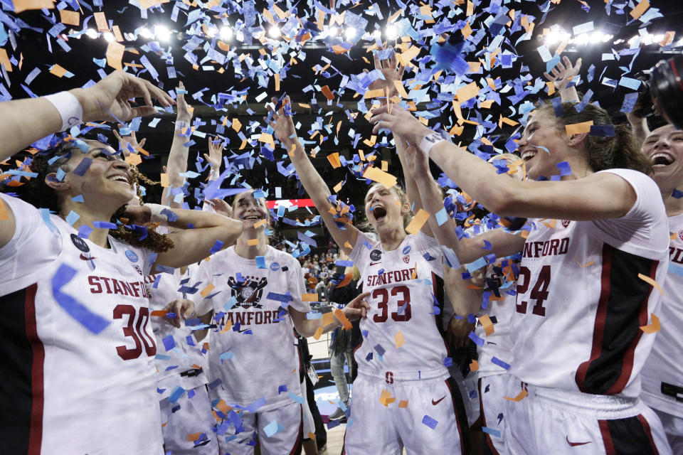 FILE - Stanford players, including Haley Jones (30), Hannah Jump (33), and Lacie Hull (24) celebrate as confetti flies after Stanford beat Texas 59-50 in a college basketball game in the Elite 8 round of the NCAA tournament, Sunday, March 27, 2022, in Spokane, Wash. Stanford is ranked No. 2 in The Associated Press Top 25 women's preseason basketball poll released Tuesday, Oct. 18, 2022. (AP Photo/Young Kwak, File)