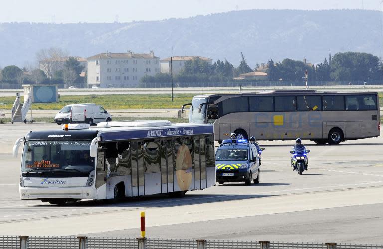 Buses carrying family members of the victims of the Germanwings plane crash are escorted by police in Marignane on March 26, 2015 before heading to the area of the crash in the Alps