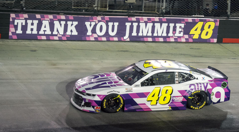 Jimmie Johnson drives past a banner on the wall at the entrance of turn three during a NASCAR Cup Series auto race at Bristol Motor Speedway in Bristol, Tenn. NASCAR's nicest guy will run his final race this week and close a remarkable career. Jimmie Johnson's record-tying seven Cup titles are well celebrated, but his charitable work goes less noticed. The Jimmie Johnson Foundation has donated more than $12 million to schools and programs since it launched. (David Crigger/Bristol Herald Courier via AP)