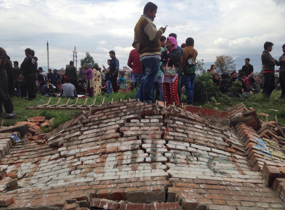 A group of people gather outdoors as the earthquake hits Kathmandu on April 25, 2015. (AP Photo/ Niranjan Shrestha)