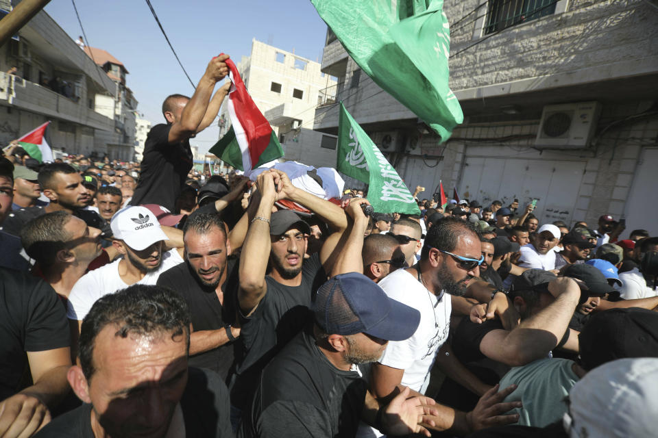 Mourners carry the body of Mohammed Obeid, a 20 year-old Palestinian killed in a clash with Israeli police on June 27, during his funeral in east Jerusalem, Monday, July 1, 2019. (AP Photo/Mahmoud Ilean)