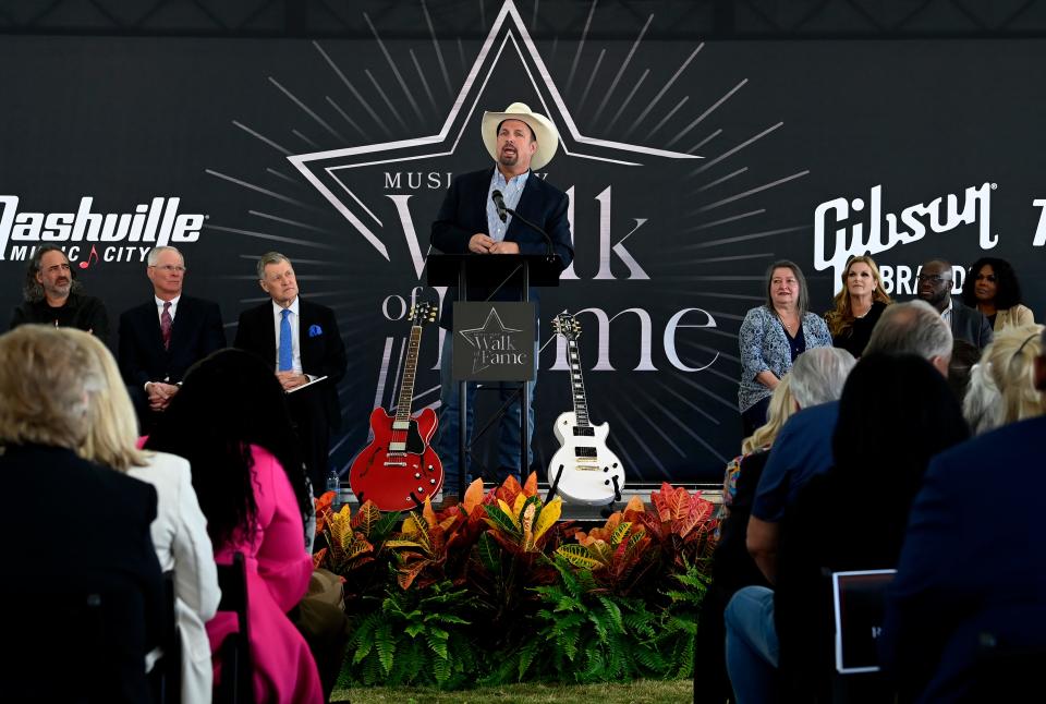 Garth Brooks speaks before presenting Kim Hardy, wife of Ed Hardy, with a honorary plaque during the Music City Walk of Fame Induction Ceremony Monday, Oct. 10, 2022, in Nashville, Tenn. 