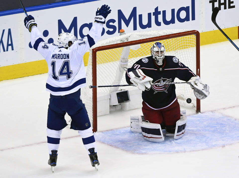 Tampa Bay Lightning left wing Pat Maroon (14) celebrates his teammates goal as Columbus Blue Jackets goaltender Joonas Korpisalo (70) looks on during the second period of an NHL Eastern Conference Stanley Cup hockey playoff game in Toronto, Saturday, Aug. 15, 2020. (Nathan Denette/The Canadian Press via AP)