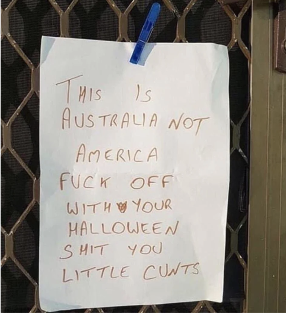 A note taped to a front door reads "this is Australia not America, fuck off with your Halloween shit you little cunts"