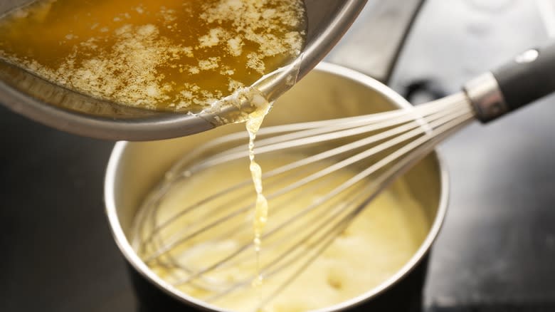 pouring melted butter into pot