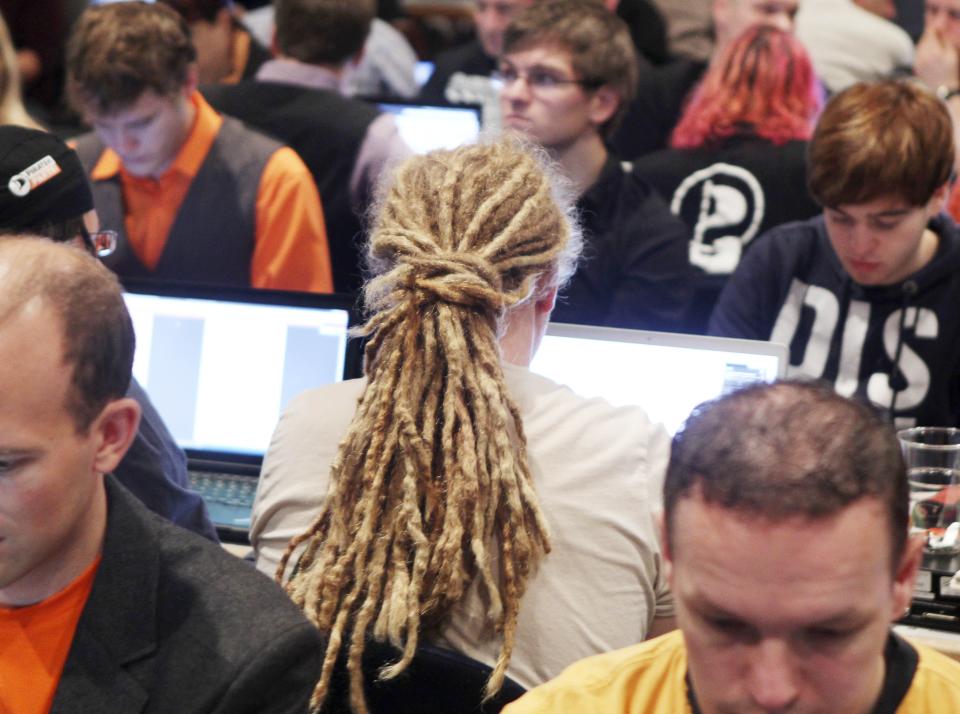 FILE - The Dec. 4, 2011 file photo shows a party member with long hair working on his notebook during a party meeting of the German Pirate Party in Offenbach, Germany. A new poll published Tuesday, April 3, 2012 shows support for Germany's upstart Pirate Party rising to a record 12 percent after its second success in a state election — underlining its arrival as a force in national politics. The Pirates, with a platform based on near-total transparency and Internet freedom, first won seats in a state legislature in Berlin last September. On March 25 they won seats in Saarland, in western Germany.(AP Photo/Michael Probst, file)