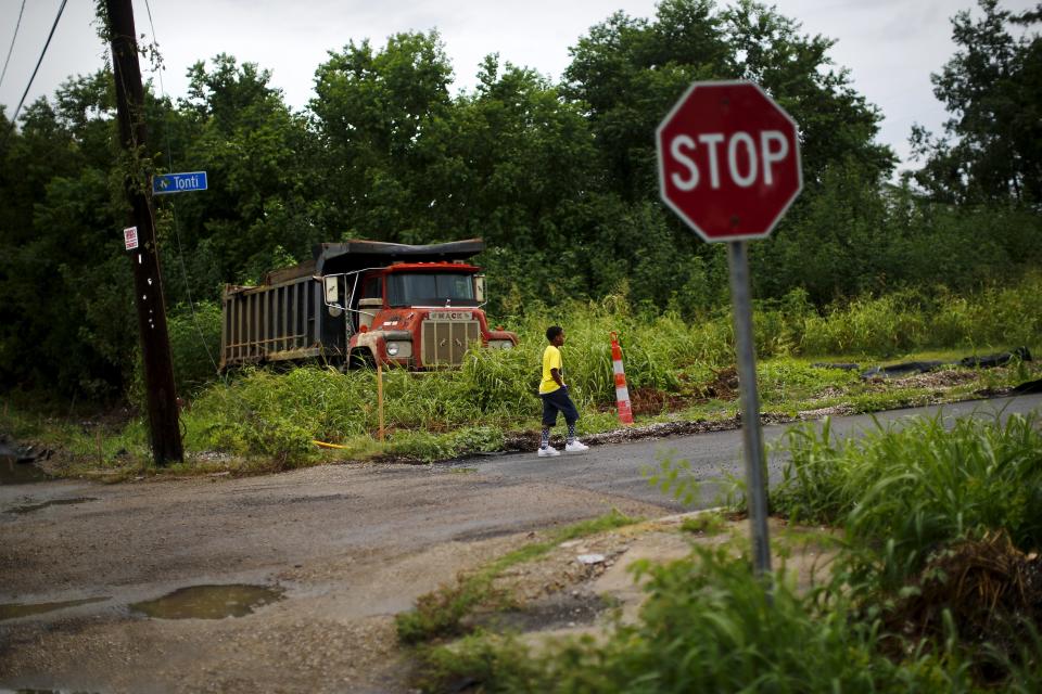 A child walks on a street in the Lower Ninth Ward neighborhood, an area damaged by Hurricane Katrina, in New Orleans, Louisiana, August 18, 2015. (REUTERS/Carlos Barria)