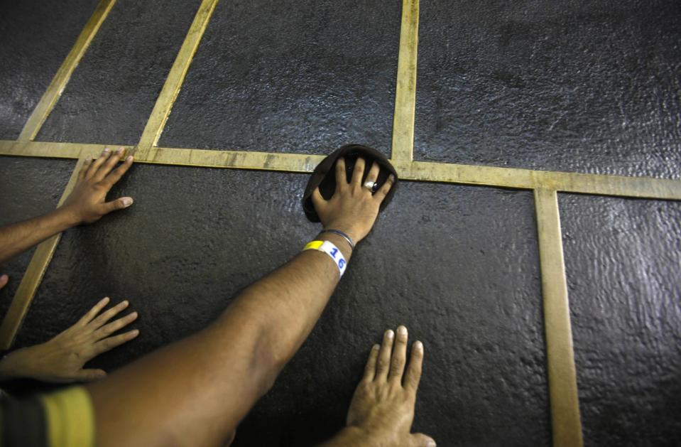 Muslim pilgrims touch the Kaaba at the Grand Mosque in the holy city of Mecca ahead of the annual Haj pilgrimage