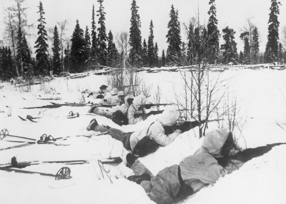 The War in Finland, 1940: A Finnish ski patrol lies in the snow on the outskirts of a wood in Northern Finland, on the alert for Russian troops, 12 January 1940.