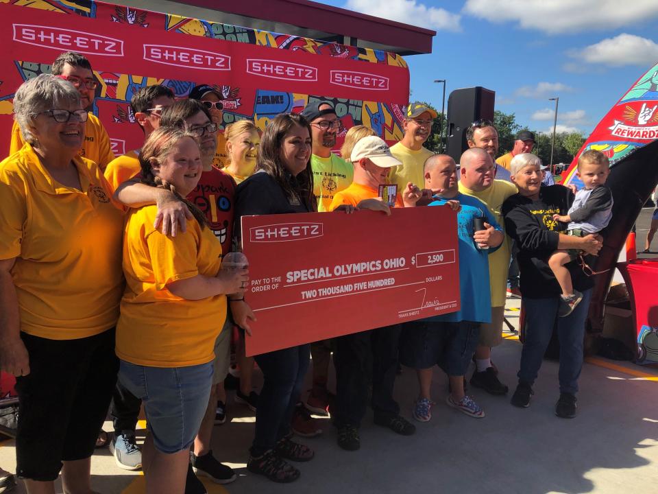 Members of the West Licking Warriors Special Olympics team accept a $2,500 donation from Sheetz during the grand opening celebration for the chain's Etna Township location. The funds will go toward uniforms, competition fees, busing for away games, and more.