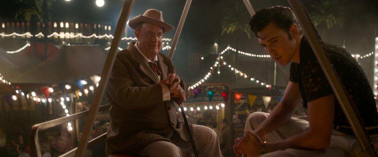 Elvis Presley, played by Austin Butler (right), had an often-contentious relationship with his longtime manager Colonel Tom Parker, played by Tom Hanks (left) in the Baz Luhrmann biopic u0022Elvis.u0022