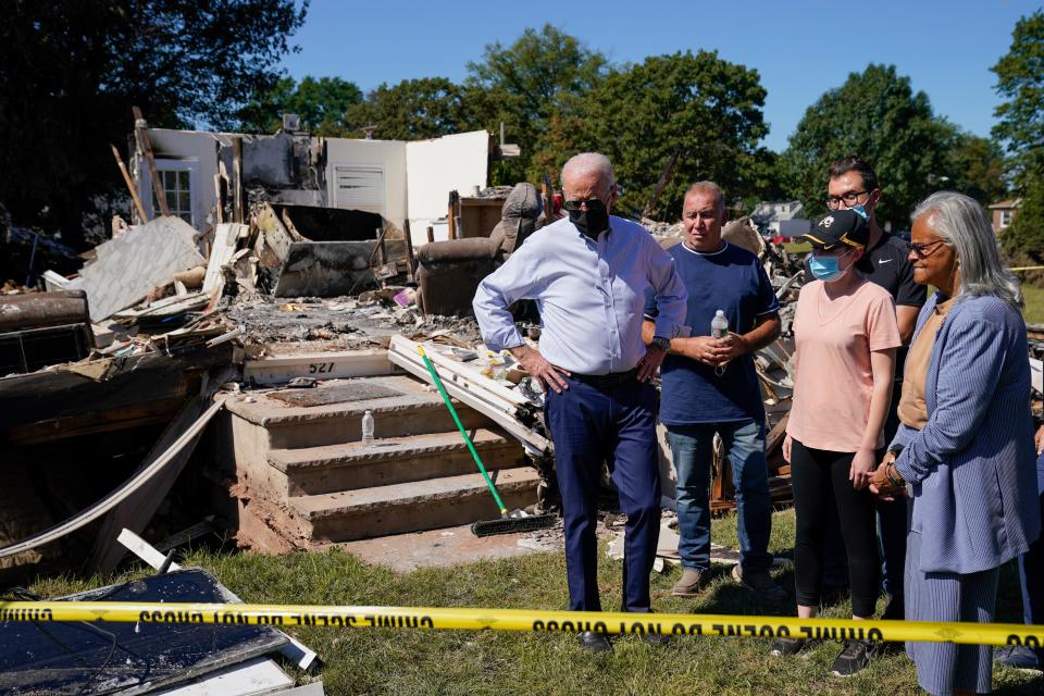 President Joe Biden tours a neighborhood impacted by Hurricane Ida, Tuesday, Sept. 7, 2021, in Manville, N.J. Rep. Bonnie Watson Coleman, D-N.J., looks on at right.