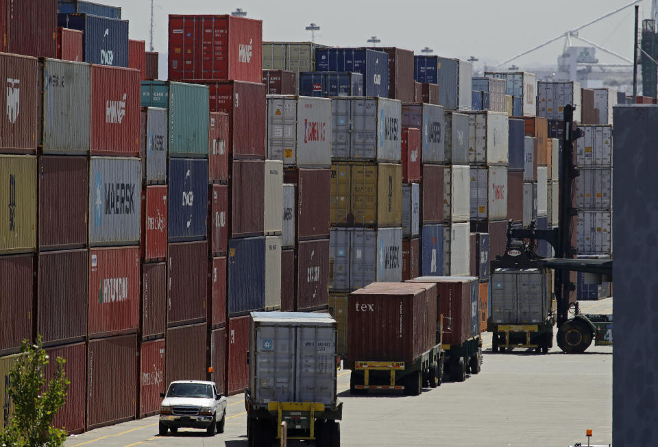 FILE - In this July 22, 2019, file stacked containers wait to be loaded on to trucks at the Port of Oakland in Oakland, Calif. China's government says trade negotiators are in “close communication” with Washington ahead of a weekend deadline for a U.S. tariff hike. But a Ministry of Commerce spokesman gave no indication of possible progress in trade talks or whether Washington might postpone the increase. (AP Photo/Ben Margot, File)