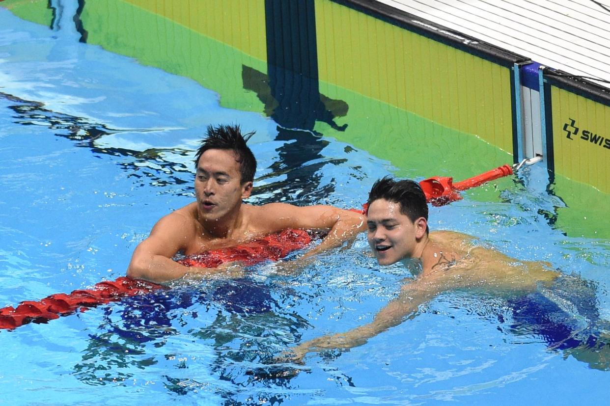 Singapore's Joseph Schooling (R) celebrates with compatriot Quah Zheng Wen after winning the men's 100m swimming butterfly during the SEA Games (Southeast Asian Games) at the Aquatic center in Clark, Capas, Tarlac province, north of Manila on December 6, 2019. (Photo by TED ALJIBE / AFP) (Photo by TED ALJIBE/AFP via Getty Images)