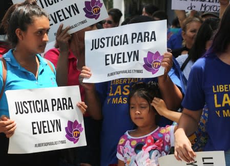 Women hold banners that read: "Justice for Evelyn" after Evelyn Hernandez, who was sentenced to 30 years in prison for a suspected abortion, was absolved at a hearing in Ciudad Delgado